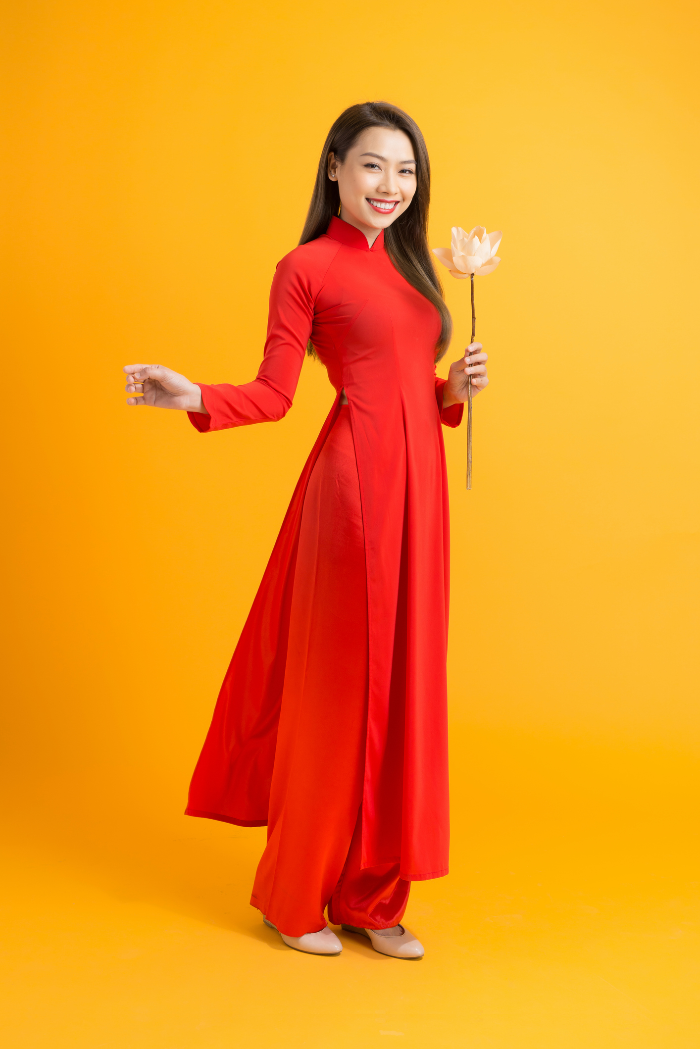 Asian beauty woman. Beautiful happy Vietnamese girl wearing national traditional red ao dai dress